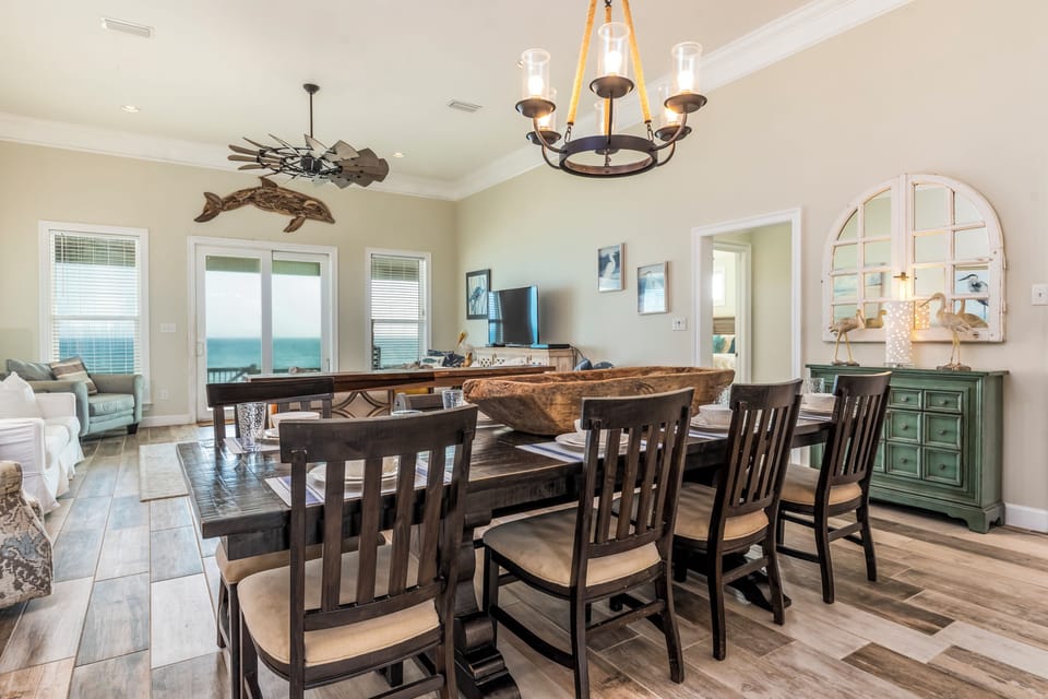 Your open living space flows seamlessly from dining to relaxation, with stunning ocean views framing every meal and moment together.