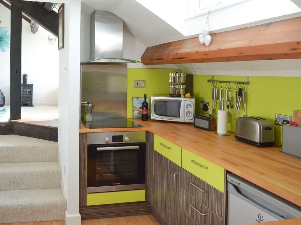 Well equipped kitchen .- showing the stairs upto the living area.
