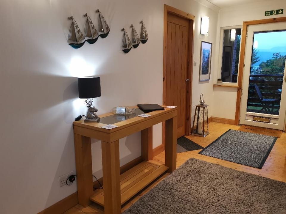 Front hall looking towards front door on to lower decked area. 