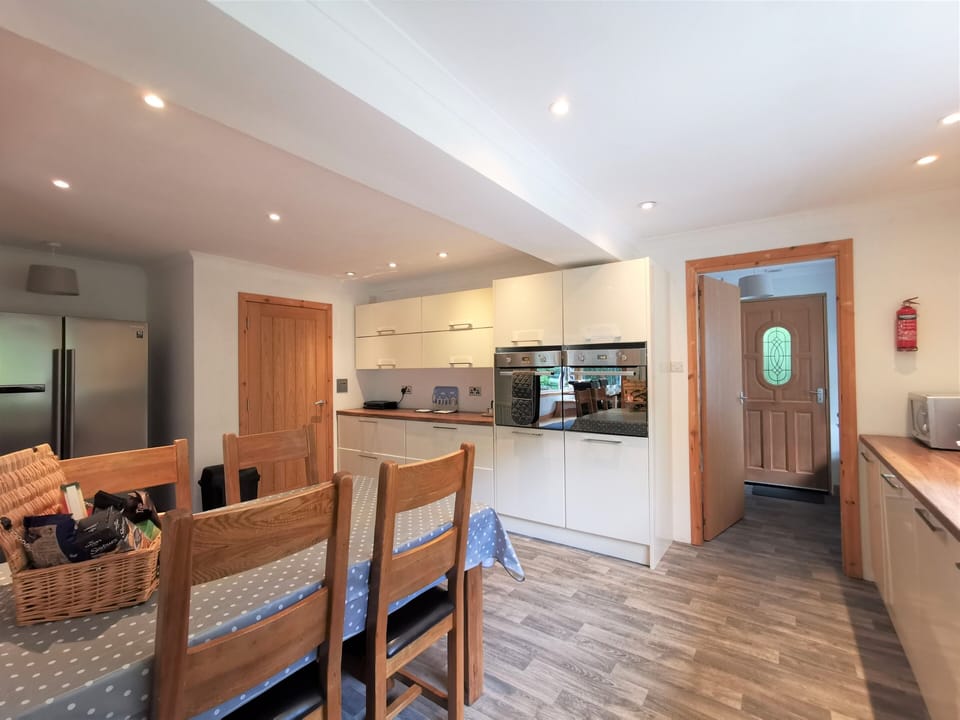 Kitchen, looking through to utility room and back door. Double ovens.
