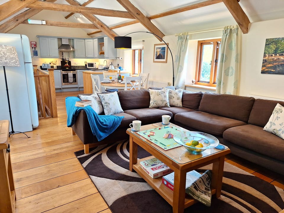 Large open plan living space with vaulted ceiling and solid English oak floor