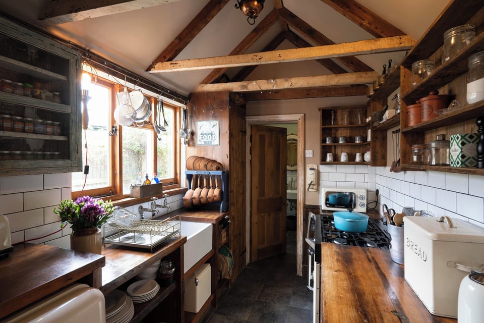 Bespoke fully equipped kitchen with vaulted ceiling and wooden worktops. 