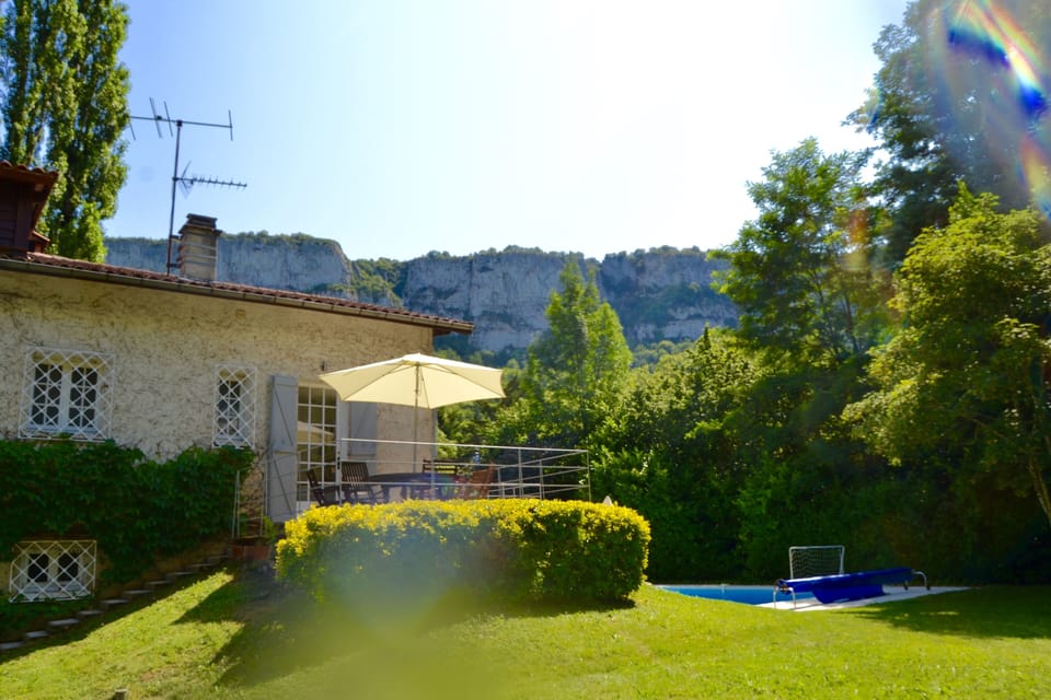 The river side of the house with terrace overlooking the pool and river