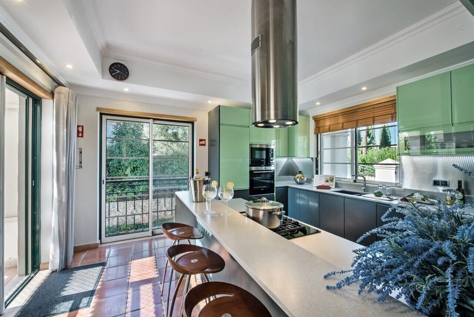 Fully integrated kitchen in warm grey and ice green  