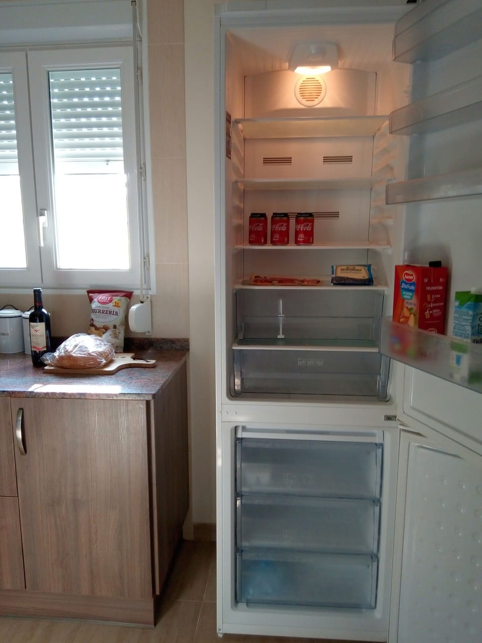 Large fridge freezer with some refreshments provided. 
