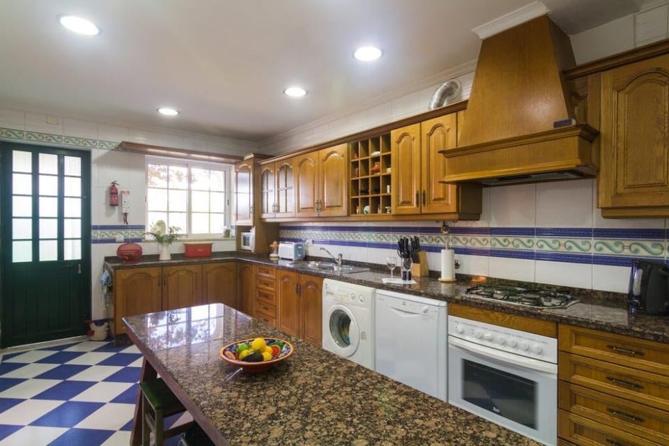 Kitchen with door to back patio and very functional dining table