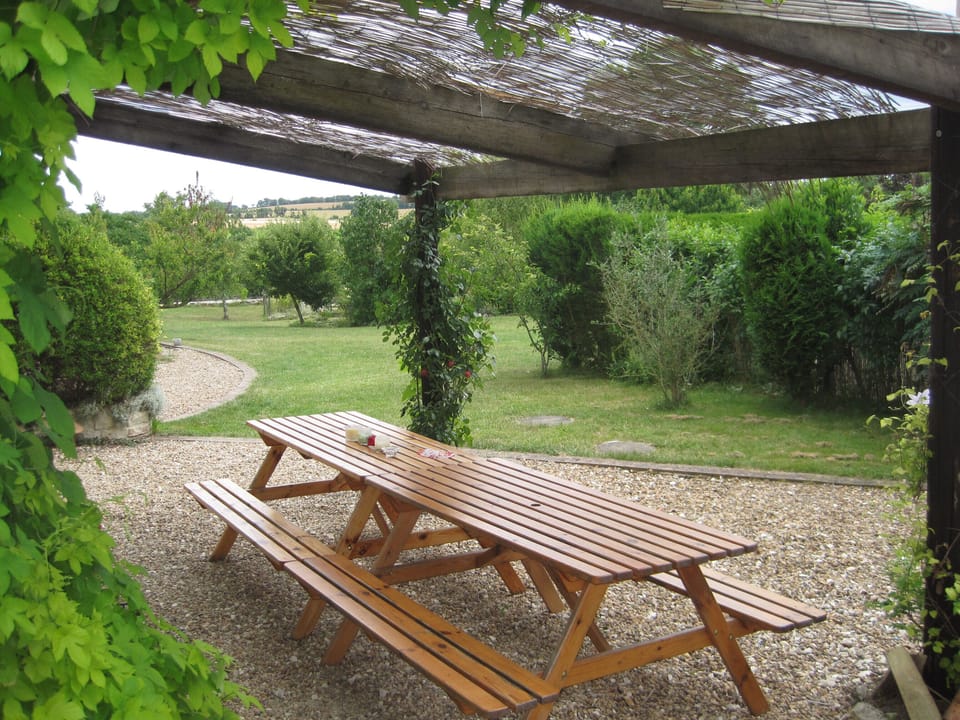 La Grange terrace area leading to shared garden, at Les Hiboux holiday rentals.