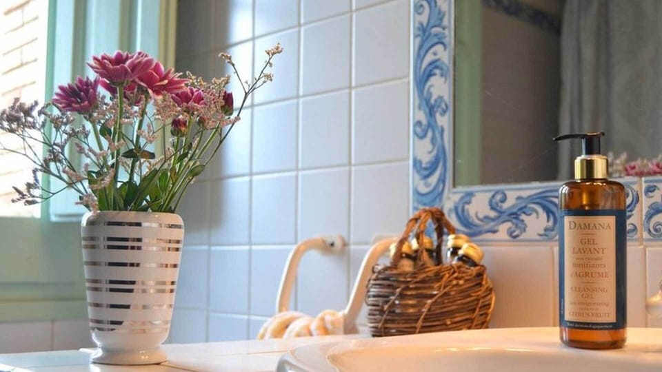 En suite baths have tub with shower, hand soap, organic toiletries & hairdryers