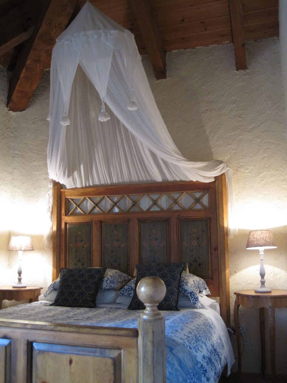 Inviting bedrooms with en suite bath, wood-beamed ceilings & local tile floors