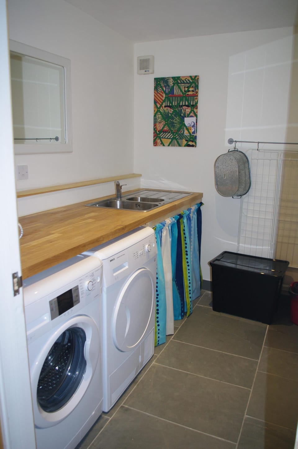Utility room with washing machine and tumble drier