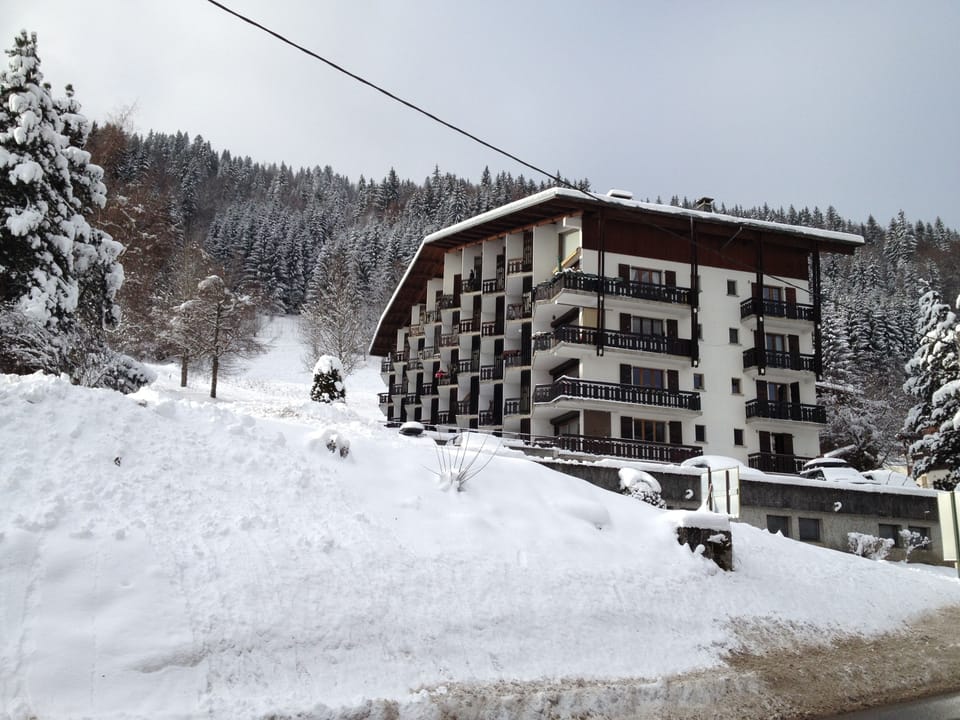 View of apartments and piste in background
