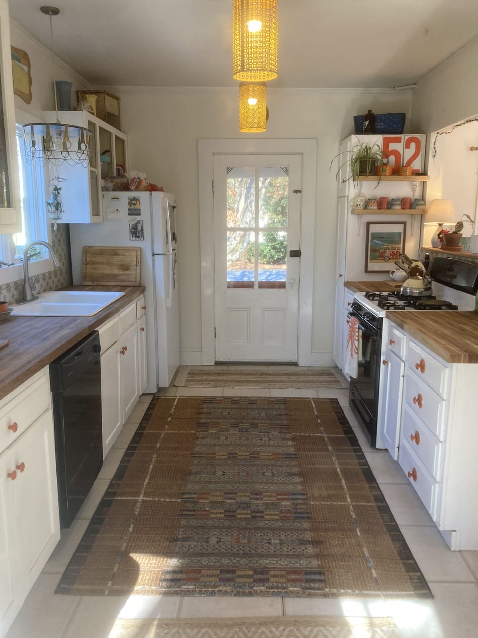 Kitchen feature gas stove and butcher block counters.