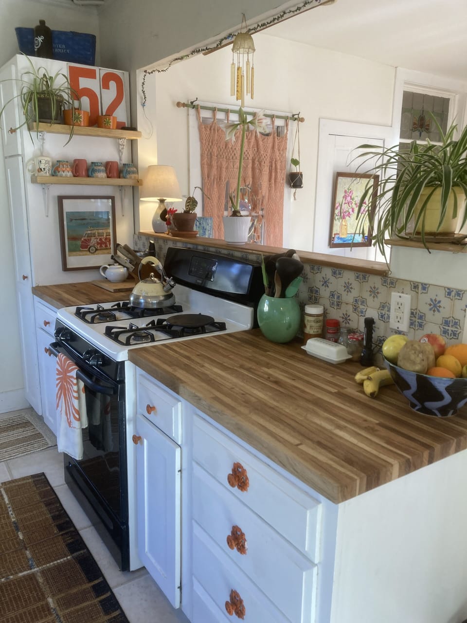 Kitchen is open to gathering space beyond.