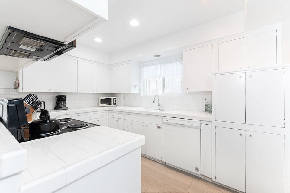 The kitchen is stocked with dishes, utensils, cookware, bakeware, and major and small appliances.
                