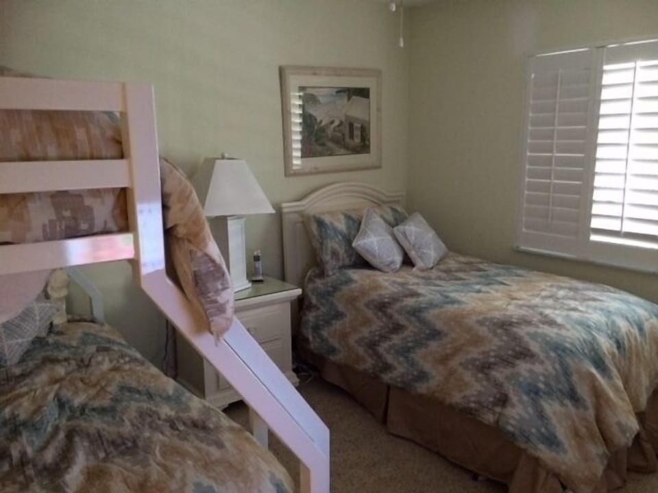 Guest bedroom with full size mattress on lower bunk