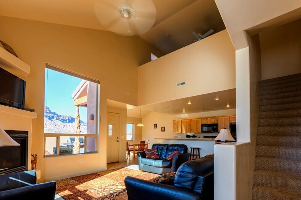 Living room with cathedral ceilings and 2 BIG picture windows.