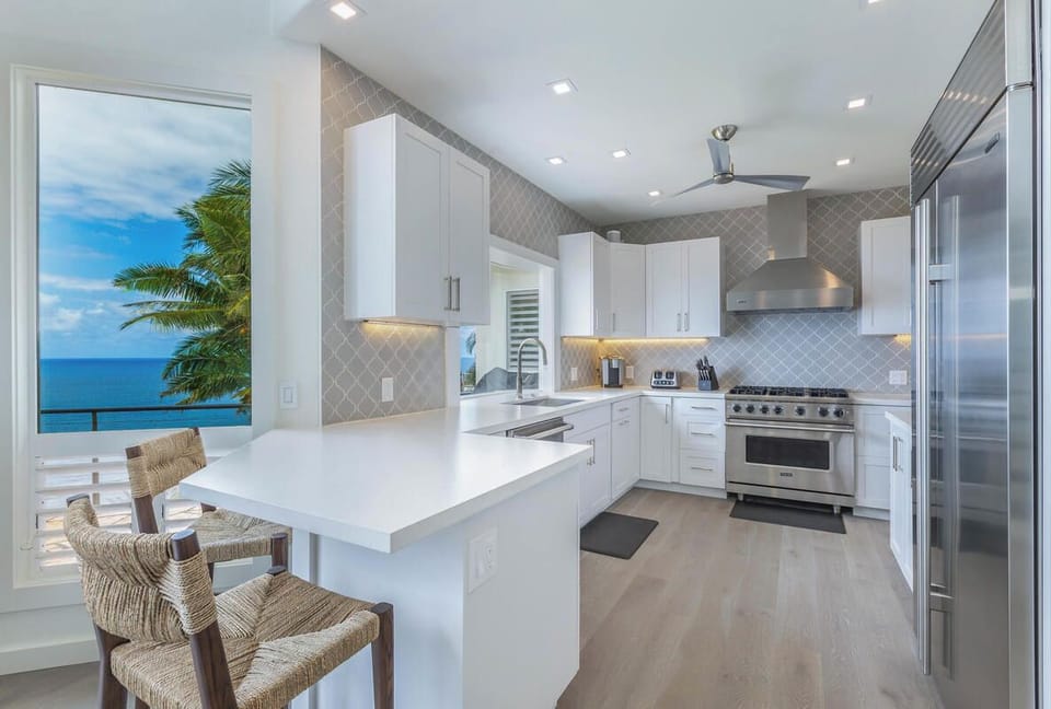 The modern kitchen is fully equipped and features convenient bar seating for casual meals or morning chats.