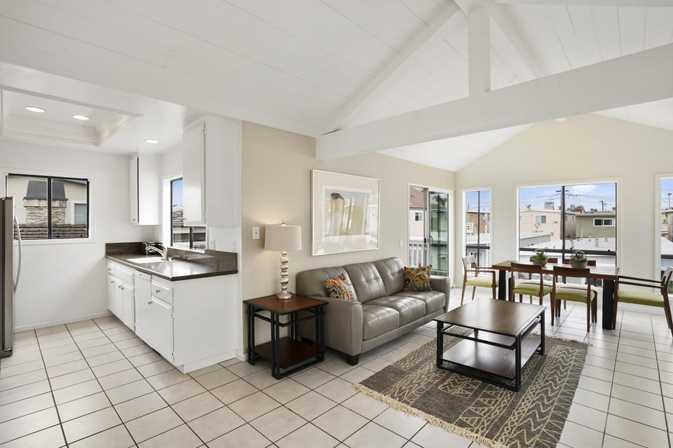 Gather together in the open concept living and dining area with glass doors leading to the front deck
                