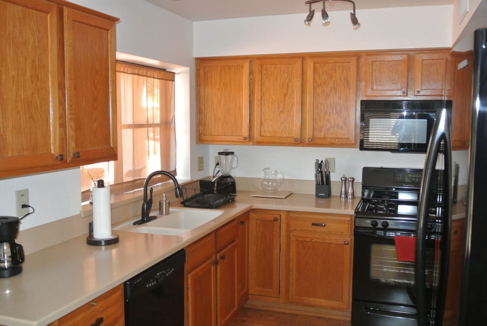 Kitchen and appliances, plenty of cabinets for storage 