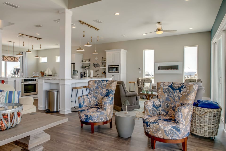 You'll love gathering in this bright open-concept space where coastal blues meet elegant comfort, perfect for relaxing after beach days.