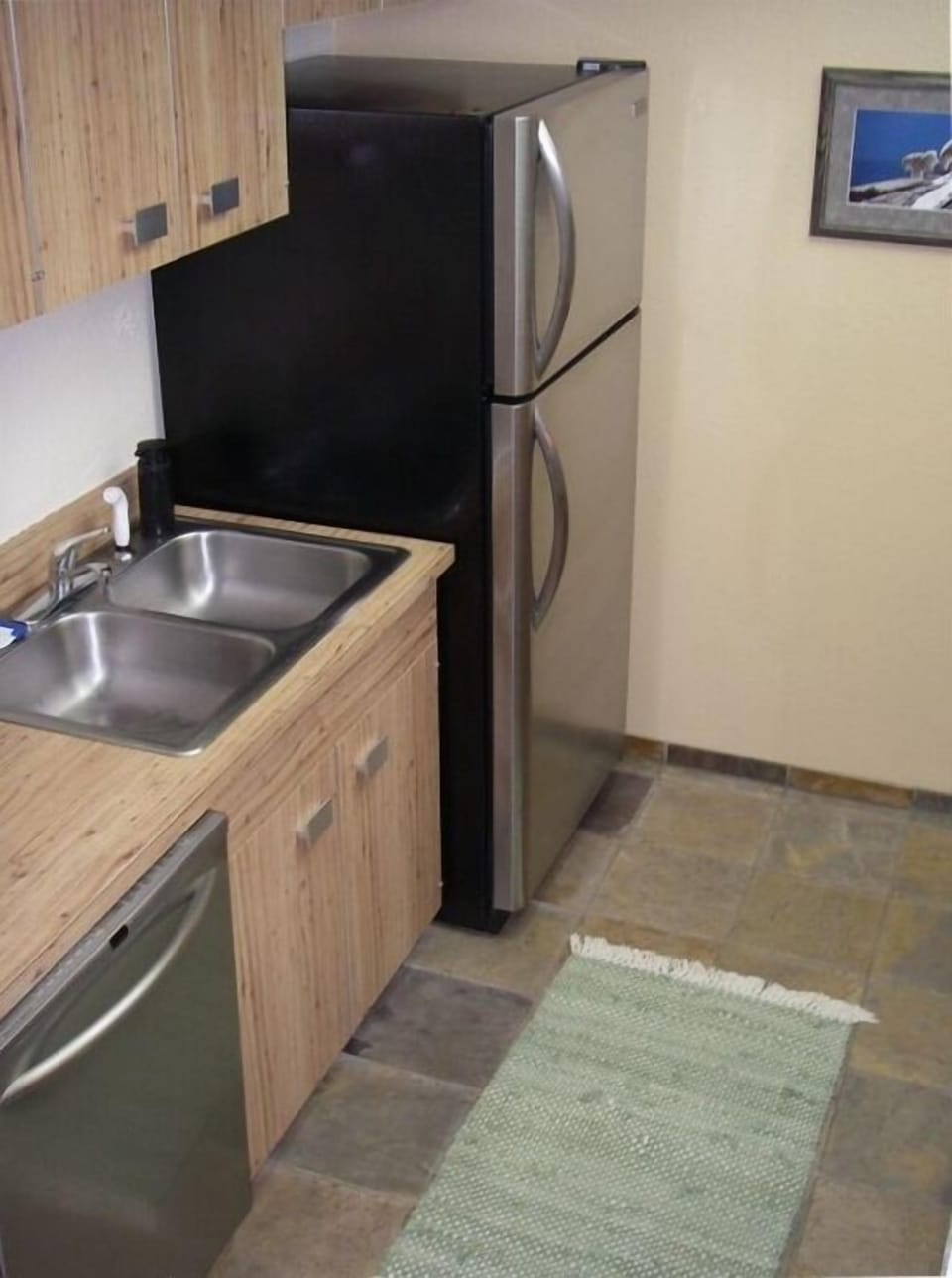 Kitchen showing dishwasher, sink, and refrigerator. 