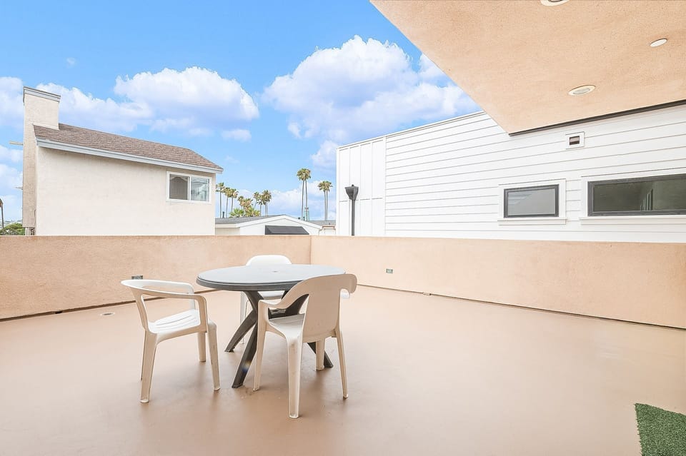 Large rear balcony deck includes dining table w/ seating; storage for outdoor gear. It looks out onto the alley.
                