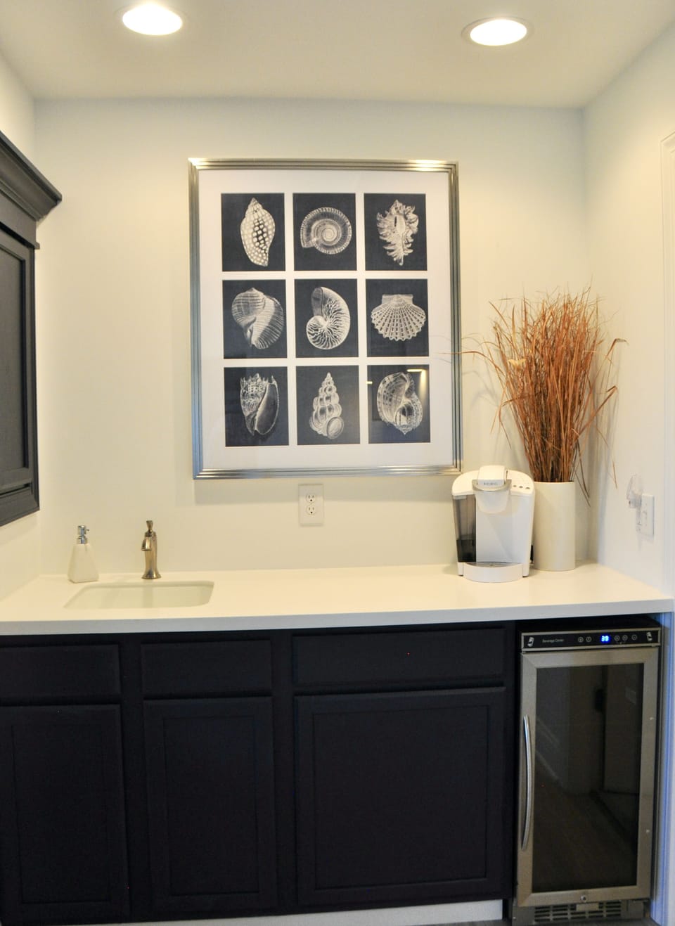 Wet bar, beverage refrigerator, micro wave; cabinets stocked :dishes and glasses