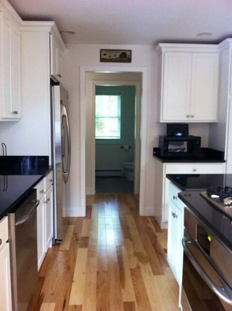 Kitchen with high end refrigerator, dishwasher, stove and oven.