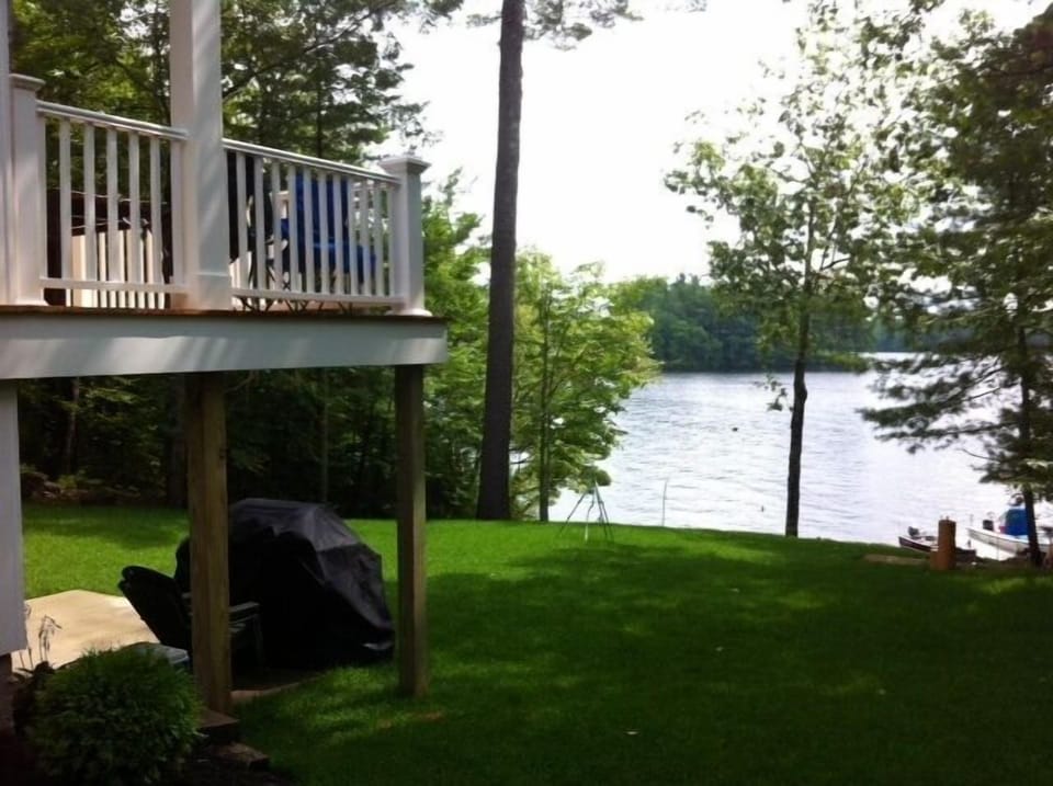 View of the yard and lake from the side of the house