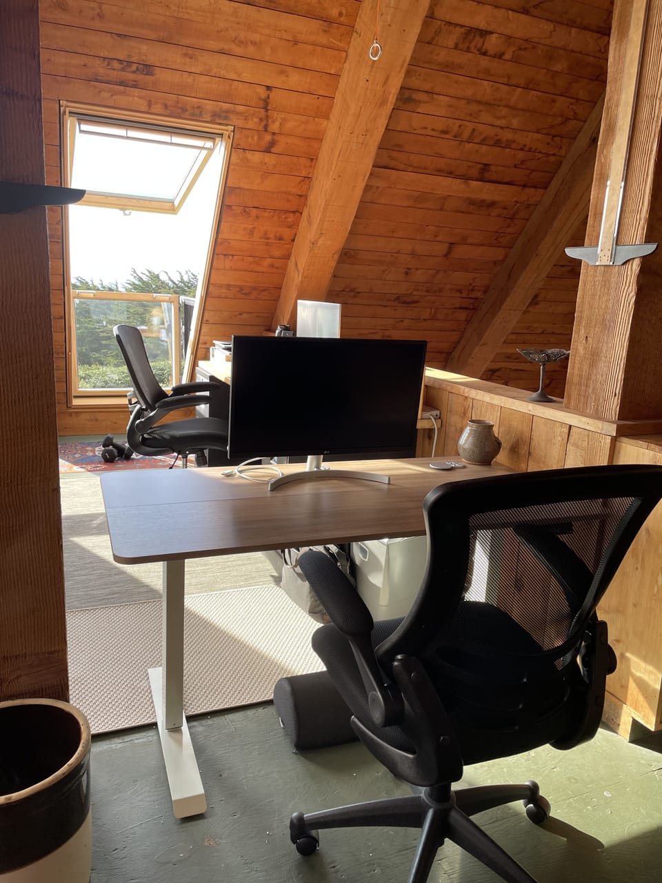 loft office space has two desks (one sit-stand hydraulic) equipped with monitors