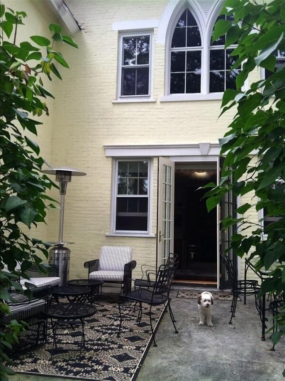 Front patio with grilling, dining and sitting areas leading to living room.  