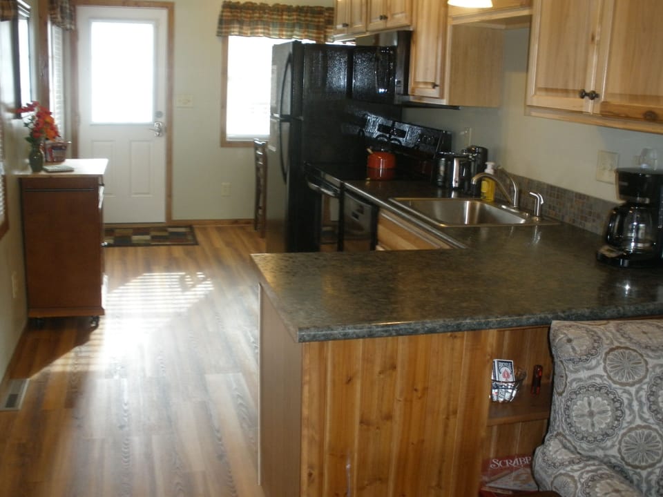 View from living room to kitchen to dining area by front door.  ALL NEW!