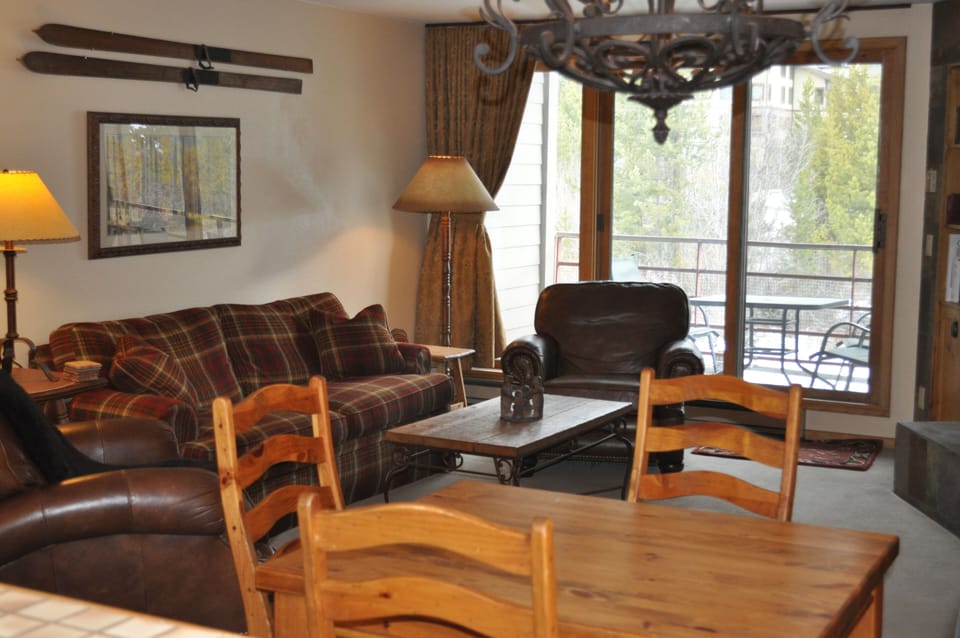 Living/dining area with deck in the background.