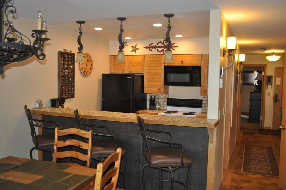 Bar and Kitchen.  Hallway to bedroom, bathroom, entry on the right.  W/D in hall