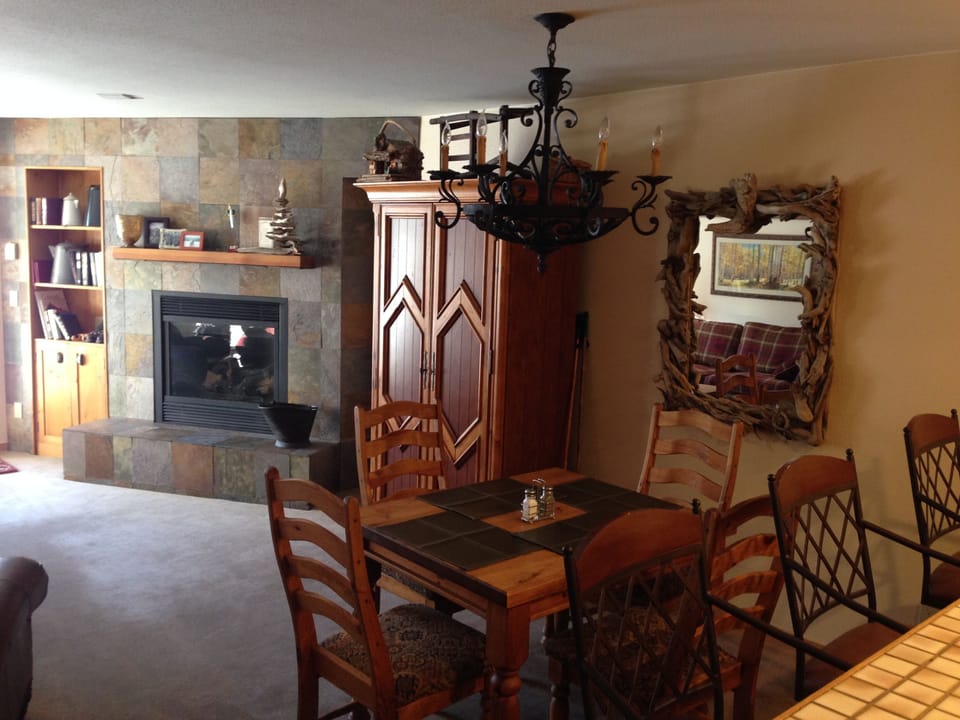 Gas fireplace and Dining area.  Flat screen TV inside entertainment unit.