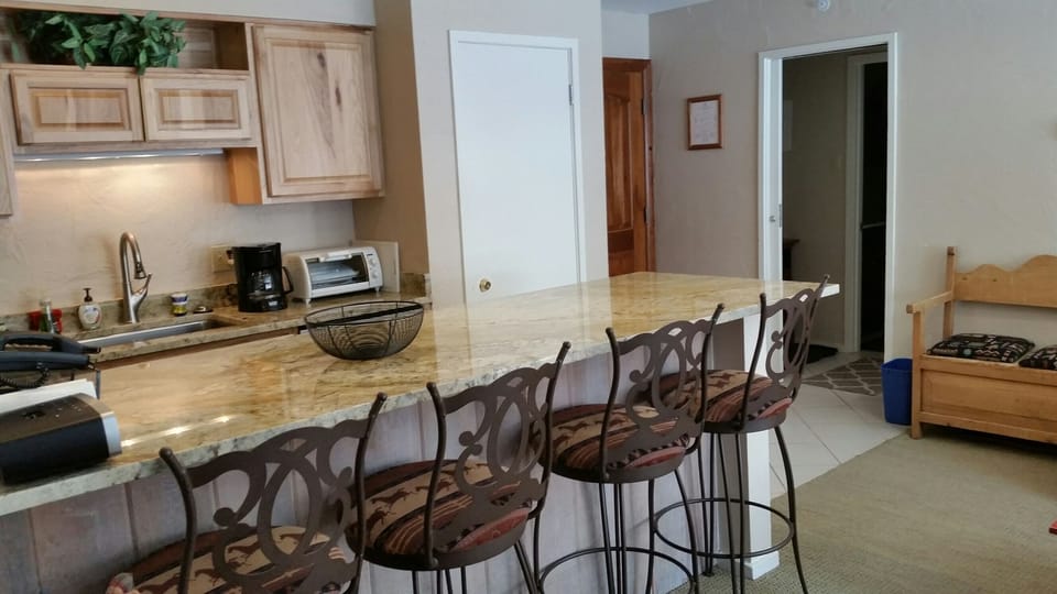 Granite island seats 4; bedroom tucked away down hall
