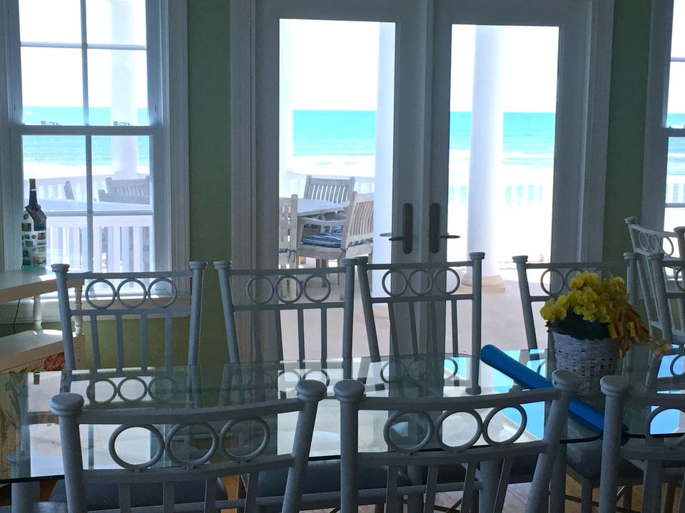 Just out the door of the dining area is the large upper deck with teak table.