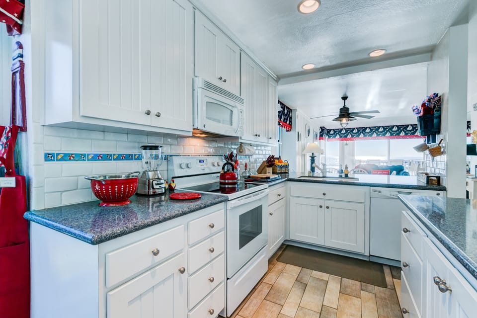 At the kitchen sink you have the full wall of ocean view.  So much light in unit