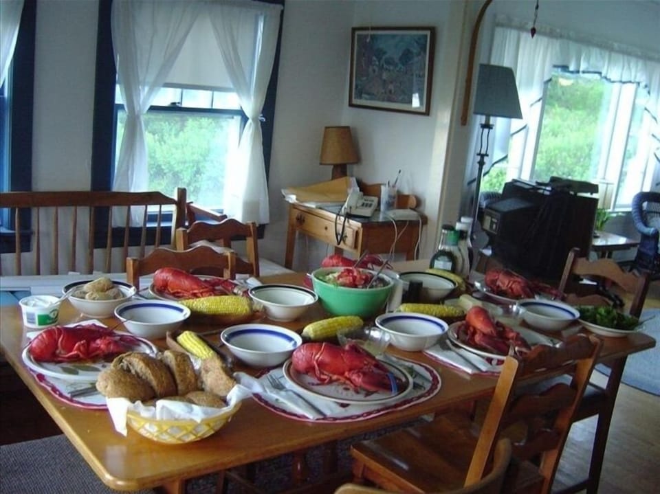 A view of dining room with  lobster dinner with all the fixings