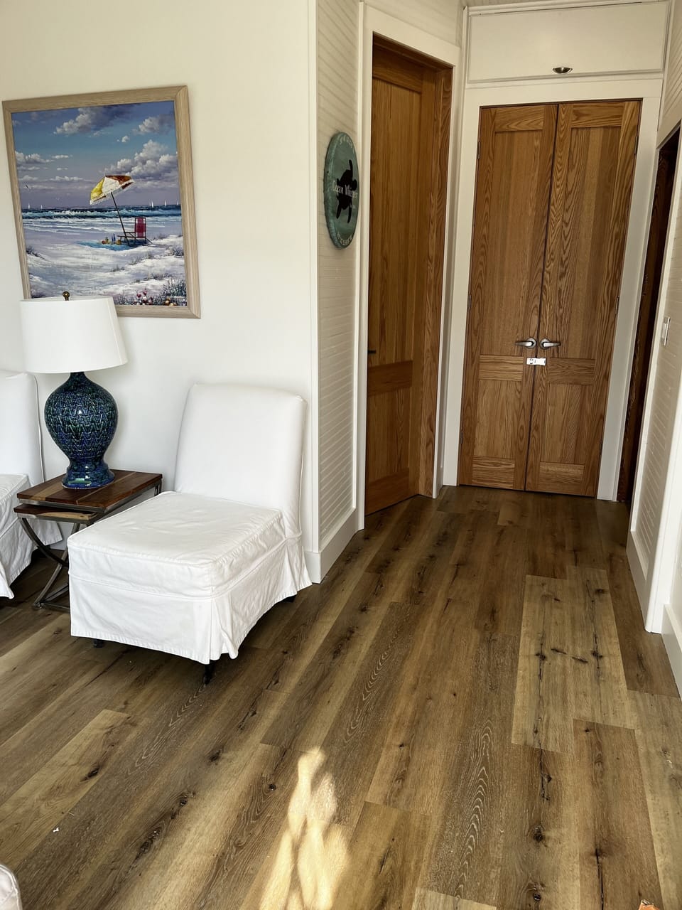 From front door looking at entry, owners closet and new bathroom.