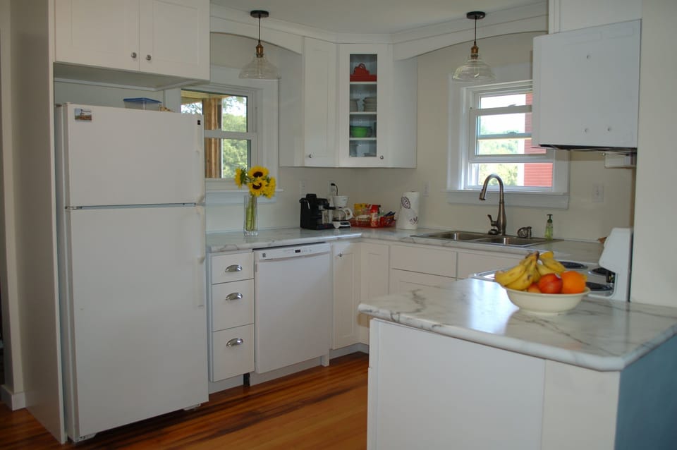 Fully-equipped kitchen with dishwasher, full-size fridge, and electric stove