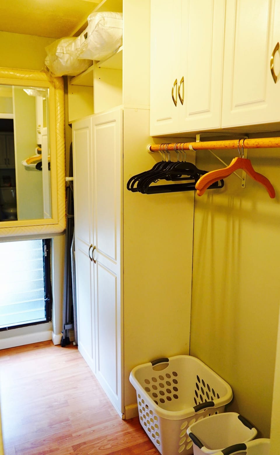 Master closet hanging space and cabinet storage