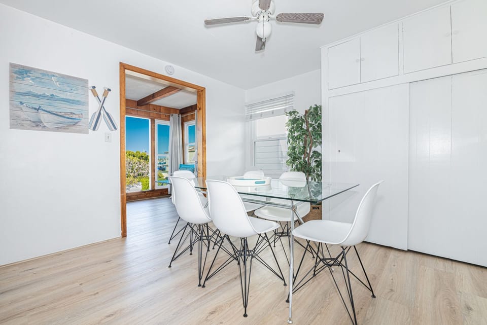 The home has been renovated with updated flooring throughout, creating a fresh, modern coastal finish
                