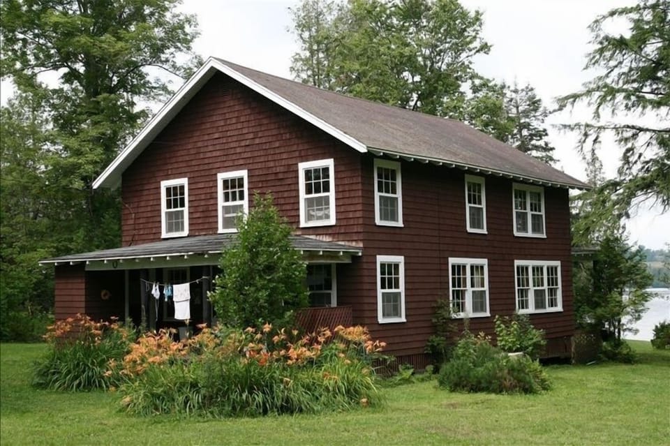 The Cottage from the back and side; large grassy yard is great for family games!