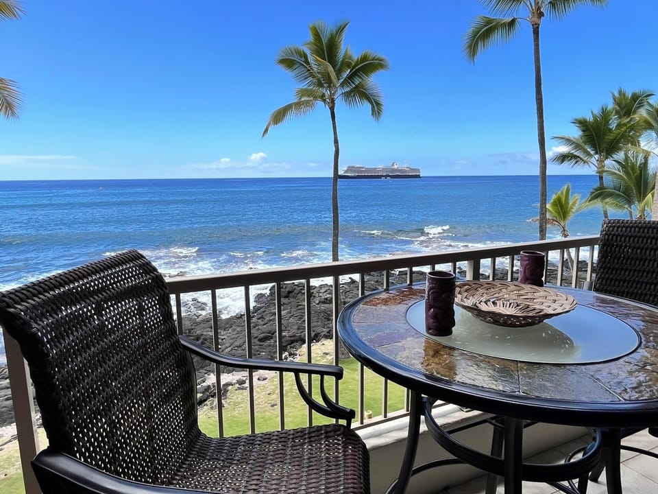 Bar-height lanai table and swivel chairs for an unobstructed oceanfront view
