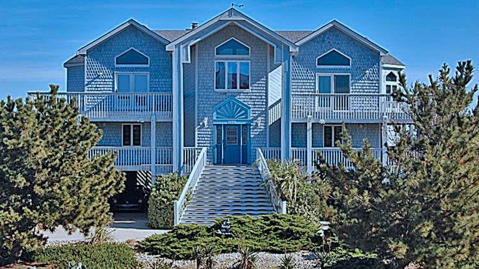 West Elevation Overlooking Landscaping and Driveways to Carports for 4 Cars
