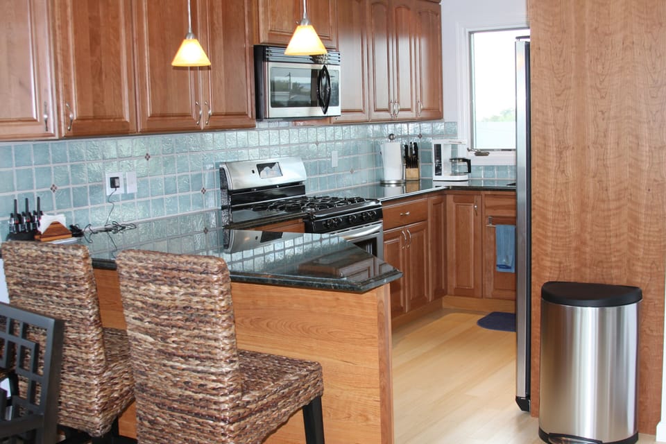 Kitchen with granite counters and peninsula seating 