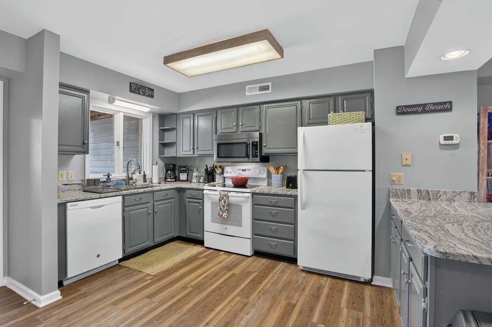 Modern, fully equipped open-concept kitchen with everything you need to prepare delicious home-cooked meals during your stay.