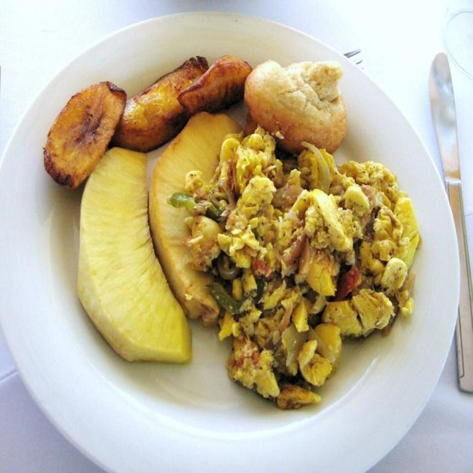 Jamaican national breakfast ackee and saltfish and roasted breadfruit