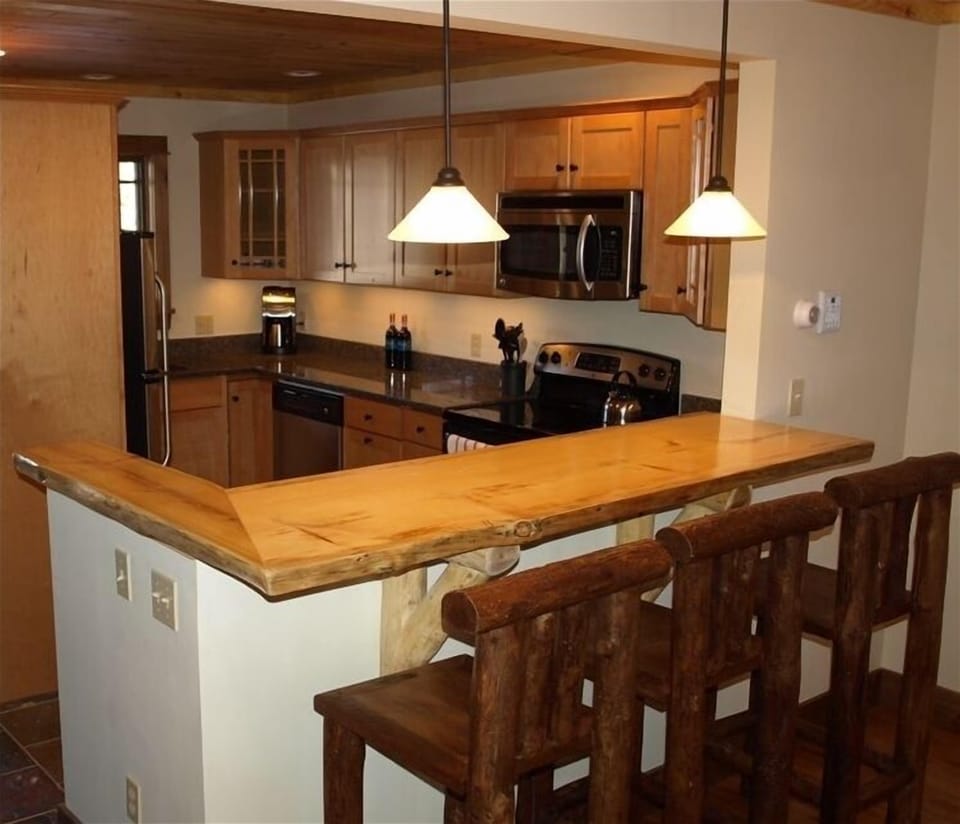 Kitchen: granite and stainless.  Wood slab bar with rustic barstools